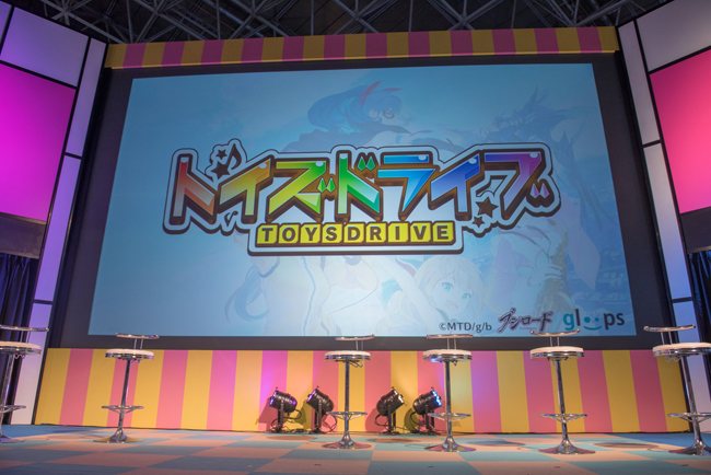 Tgs14 両社の化学反応に期待してほしい ブシロードとgloopsの新作アプリ トイズドライブ に意欲 ヱヴァbm の概要も公開 Social Game Info